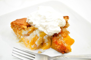 Serving of Peach Cobbler on a White Plate